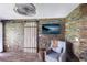 Cozy sitting area with stone accent wall and barn door at 3500 El Conquistador Pkwy # 339, Bradenton, FL 34210