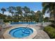Community pool and spa area with plenty of lounge chairs at 3500 El Conquistador Pkwy # 339, Bradenton, FL 34210