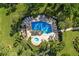 Community pool and spa surrounded by lush landscaping and lounge chairs at 3500 El Conquistador Pkwy # 339, Bradenton, FL 34210