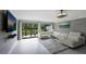 Bright living room with white sectional sofa and sliding glass doors at 3500 El Conquistador Pkwy # 339, Bradenton, FL 34210