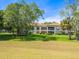 Two-story building with balconies and lush green lawn at 4427 Longmeadow # 48, Sarasota, FL 34235