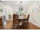 Charming dining room with hardwood floors and an elegant chandelier at 4427 Longmeadow # 48, Sarasota, FL 34235