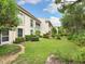 Building exterior showcases lush landscaping and private patio areas at 4427 Longmeadow # 48, Sarasota, FL 34235