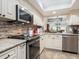 Modern kitchen with stainless steel appliances and granite countertops at 4427 Longmeadow # 48, Sarasota, FL 34235