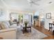 Spacious living room featuring hardwood floors, comfortable furniture, and views to the dining room and bedroom at 4427 Longmeadow # 48, Sarasota, FL 34235