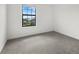 Spacious bedroom with a large window and grey carpet at 15425 White Linen Dr, Bradenton, FL 34211