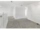 Spacious loft area with gray carpeting and railing at 15425 White Linen Dr, Bradenton, FL 34211