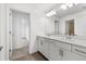 Modern bathroom with double vanity and tile flooring at 15425 White Linen Dr, Bradenton, FL 34211