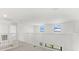 Bright loft landing overlooking the first floor with white railings and carpet at 15425 White Linen Dr, Bradenton, FL 34211