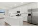 Modern kitchen with island, stainless steel appliances, and white cabinets at 15425 White Linen Dr, Bradenton, FL 34211