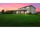 Large backyard with a view of the house at sunset at 15425 White Linen Dr, Bradenton, FL 34211