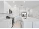 Well-lit kitchen with quartz counters, stainless appliances, and ample cabinet space at 3063 Novara Ln, Lakewood Ranch, FL 34211