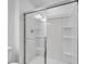 The bathroom showcases a streamlined glass-enclosed shower, featuring built-in shelving for bathroom essentials at 3063 Novara Ln, Lakewood Ranch, FL 34211