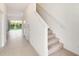 Hallway with tile floors leading to outdoor views and carpeted stairs at 3067 Novara Ln, Lakewood Ranch, FL 34211