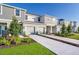 Exterior view of townhomes with landscaping and driveway at 3145 Novara Ln, Lakewood Ranch, FL 34211