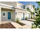 Townhome entrance with teal door, landscaping, and attached garage at 3145 Novara Ln, Lakewood Ranch, FL 34211