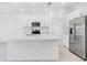 Modern kitchen with white cabinets, stainless steel appliances, and an island at 3145 Novara Ln, Lakewood Ranch, FL 34211