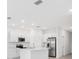 Modern kitchen with white cabinets, stainless steel appliances and island at 3145 Novara Ln, Lakewood Ranch, FL 34211