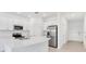 Modern kitchen with white cabinets, stainless steel appliances and island at 3145 Novara Ln, Lakewood Ranch, FL 34211