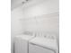 Laundry room with washer and dryer and wire shelving at 3145 Novara Ln, Lakewood Ranch, FL 34211