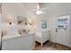Charming bedroom with twin beds, wood floors, and coastal decor at 2701 Gulf Dr, Holmes Beach, FL 34217