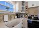 White farmhouse sink and modern appliances in a bright and airy kitchen at 2701 Gulf Dr, Holmes Beach, FL 34217
