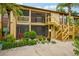 Two-story condo building with wooden stairs and landscaped grounds at 5793 Avista Dr, Sarasota, FL 34243