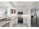 Contemporary kitchen with stainless steel appliances, granite countertops, and white cabinetry at 1260 Dolphin Bay Way # 203, Sarasota, FL 34242