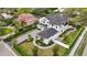 A beautiful home is surrounded by lush green trees and manicured landscaping in this aerial view at 1783 Bayview Dr, Sarasota, FL 34239