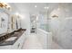 This spacious bathroom is complete with a walk-in shower, double vanity, and elegant fixtures at 1783 Bayview Dr, Sarasota, FL 34239