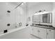 Modern bathroom features a glass walk-in shower, a vanity with granite countertops, and a sleek, minimalist design at 1783 Bayview Dr, Sarasota, FL 34239