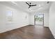 Bright and airy bedroom with hardwood floors, a tray ceiling, and access to the outdoors at 1783 Bayview Dr, Sarasota, FL 34239