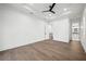 Spacious bedroom featuring hardwood floors, a tray ceiling, and neutral walls for a modern aesthetic at 1783 Bayview Dr, Sarasota, FL 34239