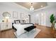 Spacious bedroom features a chandelier, hardwood floors and walk-in closet at 1783 Bayview Dr, Sarasota, FL 34239