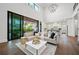 Open-concept living room featuring high ceilings, a modern chandelier, and seamless indoor/outdoor flow at 1783 Bayview Dr, Sarasota, FL 34239