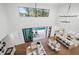 Open-concept living room featuring hardwood floors, a high ceiling, and seamless indoor-outdoor flow to the pool at 1783 Bayview Dr, Sarasota, FL 34239