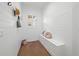 Charming mudroom features shiplap walls, built-in bench seating, and ample storage space at 1783 Bayview Dr, Sarasota, FL 34239