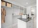 A custom walk-in closet features built-in shelving, drawers, and a central island with grey countertop at 1783 Bayview Dr, Sarasota, FL 34239