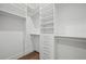 Spacious walk-in closet with custom shelving, drawers, and ample hanging space for an organized wardrobe at 1783 Bayview Dr, Sarasota, FL 34239
