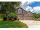 Two-story house with a three-car garage and manicured lawn at 5919 Lexington Dr, Parrish, FL 34219