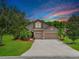 Charming home boasts a well-manicured lawn, mature trees, and a two-car garage, creating an inviting curb appeal at 5919 Lexington Dr, Parrish, FL 34219