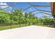 Screened lanai offers a tranquil outdoor space with views of lush greenery, perfect for relaxation and entertainment at 5919 Lexington Dr, Parrish, FL 34219
