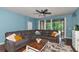 Spacious living room with sectional sofa and sliding glass doors leading to a patio at 5919 Lexington Dr, Parrish, FL 34219