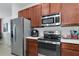 Stainless steel appliances and ample cabinetry in this modern kitchen at 5919 Lexington Dr, Parrish, FL 34219