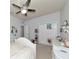 Well-lit bedroom with white bed, closet, and ceiling fan at 5919 Lexington Dr, Parrish, FL 34219