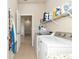 Laundry room with washer, dryer, and storage shelves at 5919 Lexington Dr, Parrish, FL 34219