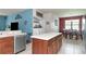 Modern kitchen with island, stainless steel appliances, and dining area at 5919 Lexington Dr, Parrish, FL 34219
