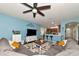 Living room with sectional sofa, wood flooring, and a ceiling fan at 5919 Lexington Dr, Parrish, FL 34219