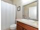 Clean bathroom with single vanity, shower/tub combo, and white accents at 5919 Lexington Dr, Parrish, FL 34219