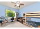 Light blue bedroom featuring a bunk bed and a small sitting area at 5919 Lexington Dr, Parrish, FL 34219